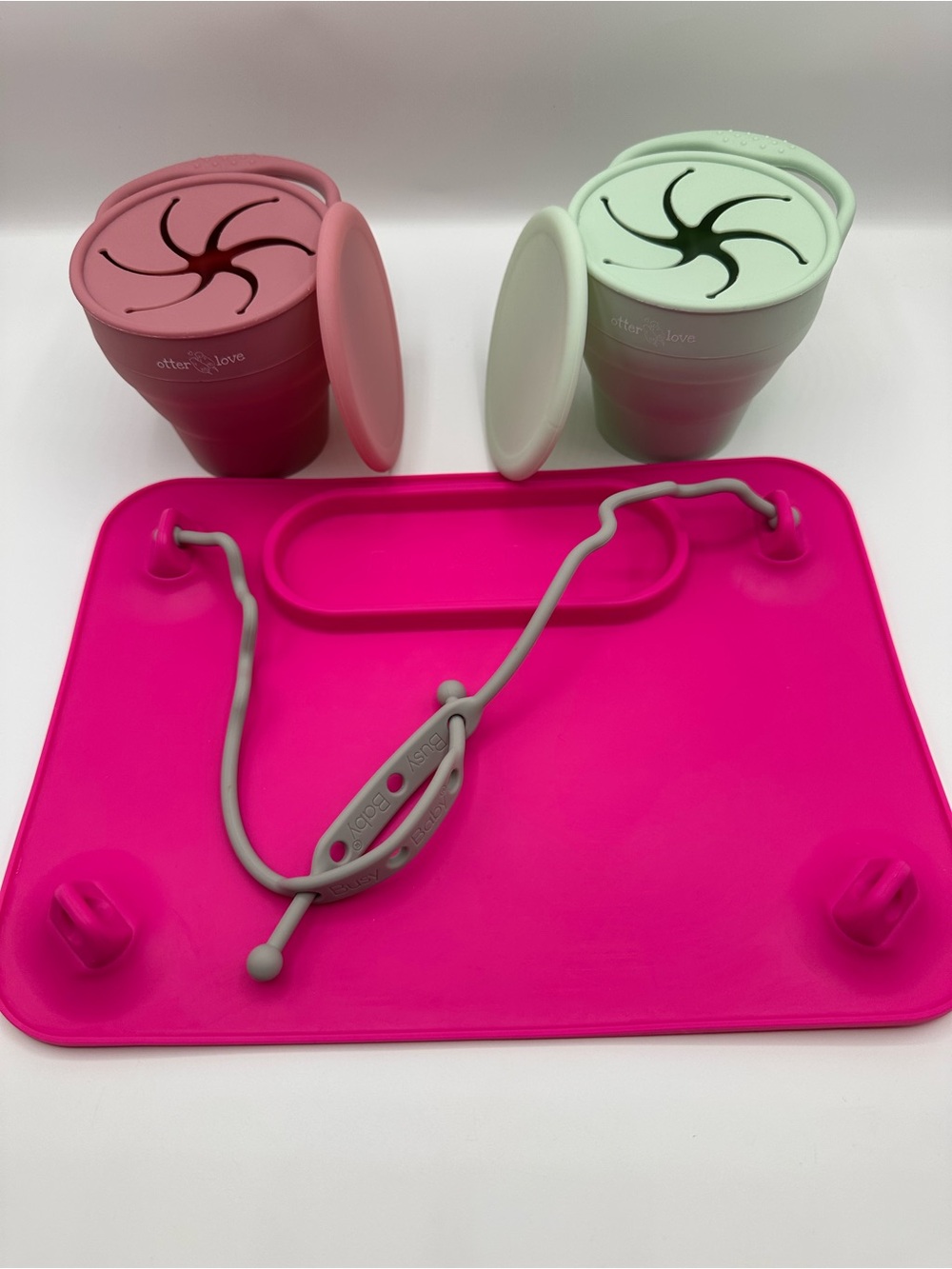 Busy Baby suction mat with a cup holder and two otter love snack containers